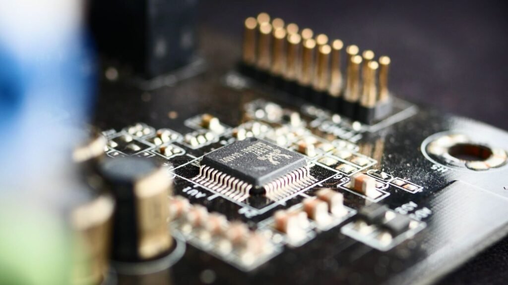 Huawei Says Its New Chip Is Free of American Technology. The Tools That Built It Are Not. Macro shot of a processor chip mounted on a circuit board, representing Huawei's Kirin 9050 Pro