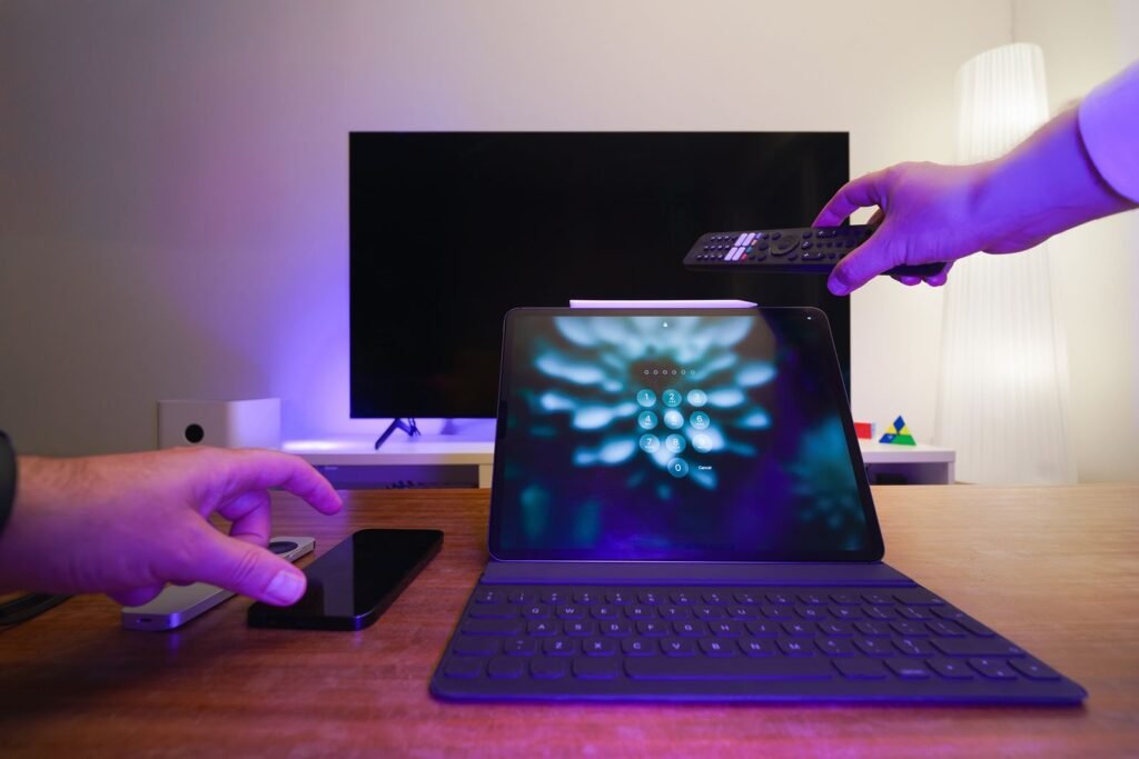 A living room with a television, tablet and smartphone, representing the Apple TV and Apple Arcade services now bundled into iCloud+