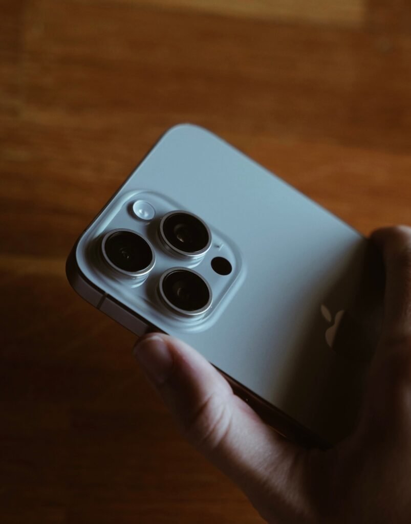 iOS 27 Is Making Some iPhones Stutter. The Fix Is Not Coming in 27.1. Close-up of a person holding an iPhone, illustrating iOS 27 touchscreen and performance issues