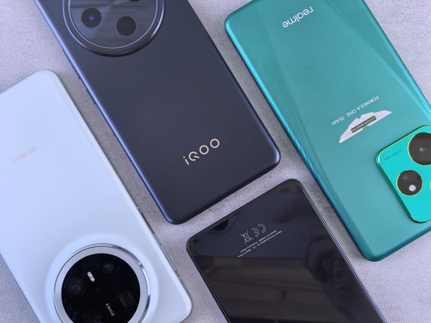 Flat lay of several smartphone models lined up side by side showing different finishes
