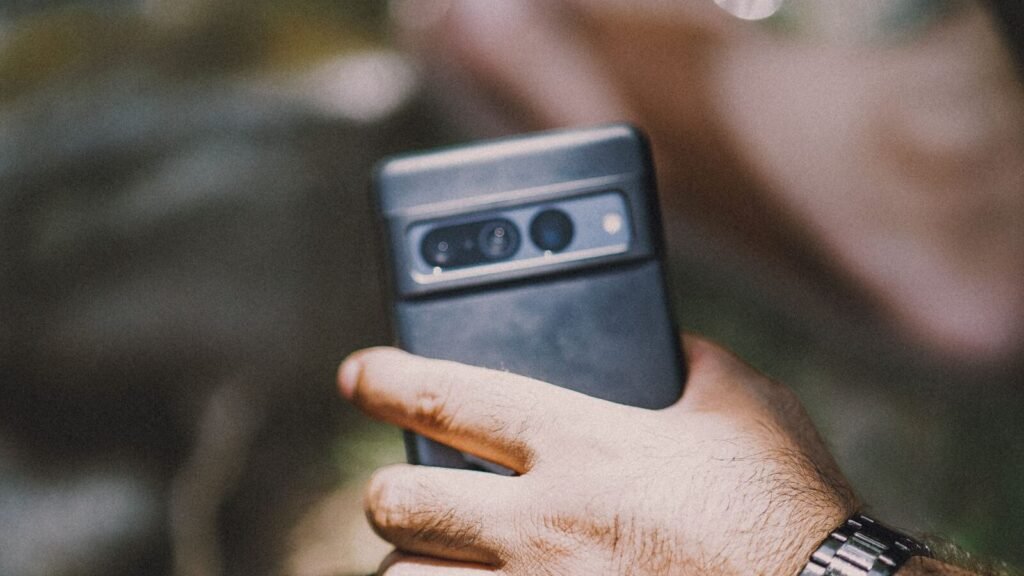 Best Smartwatches for Men in 2026: Rugged, Business, and Big-Wrist Picks Man checking a rugged smartwatch on his wrist outdoors