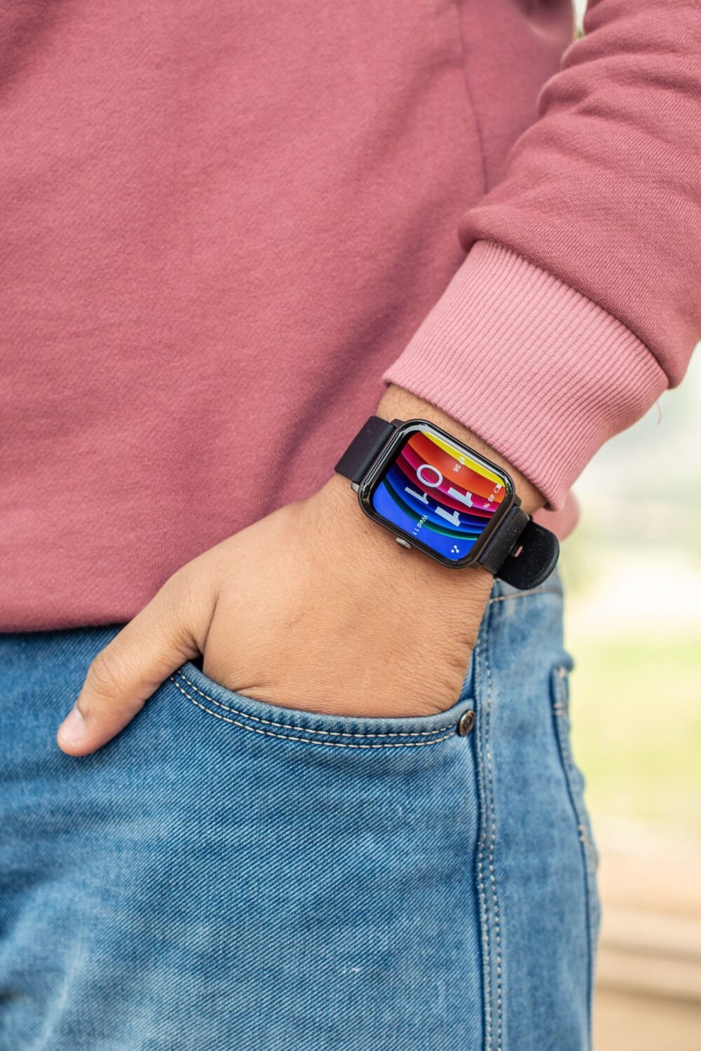 Man wearing a smartwatch with his hand resting in his jacket pocket