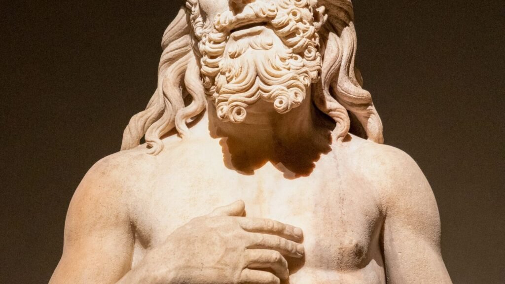 Musk Paid $175,000 for a Historically Accurate Odyssey. The Winner Gave the Cyclops Three Eyes. A detailed marble statue of an ancient Greek god, illustrating the classical source material behind the AI Odyssey contest
