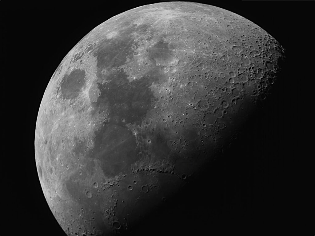 Close-up view of the Moon showing craters and surface texture along the terminator line