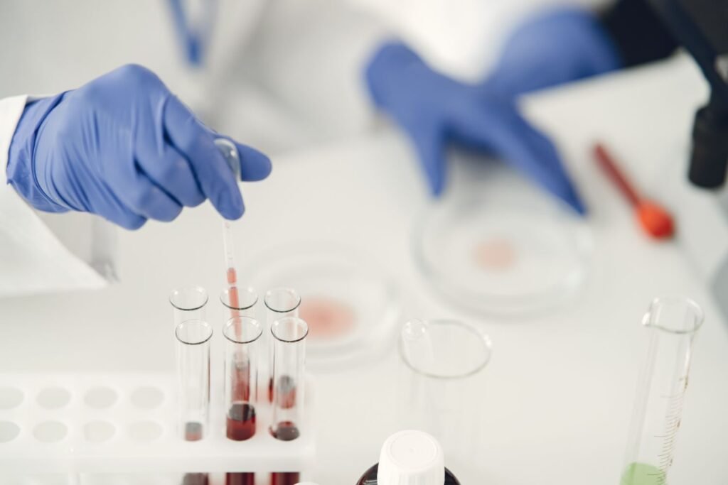 Ozempic’s Maker Just Put Claude in the Lab. Nine Out of Ten Drugs Still Fail. Researcher using a dropper pipette to collect a chemical sample in a pharmaceutical laboratory