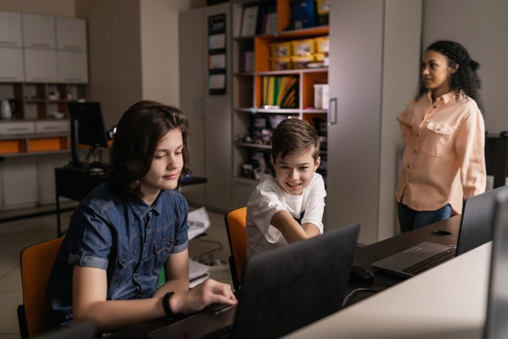 Students working on laptops in a classroom, illustrating the New York City generative AI moratorium