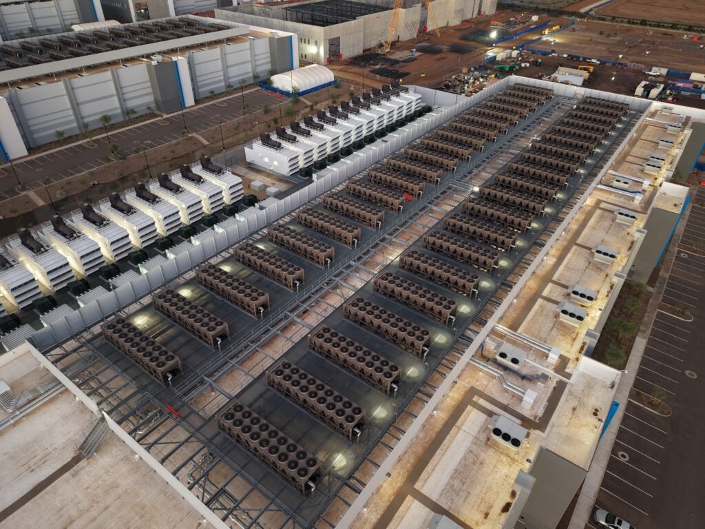 Rows of data center cooling and power equipment representing the infrastructure behind AI model training
