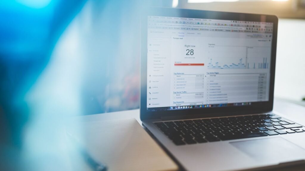 How to Find Search Queries in Google Analytics 4 Laptop showing Google Analytics in a modern workspace