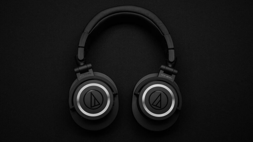 Black over-ear wireless headphones photographed from above on a plain surface