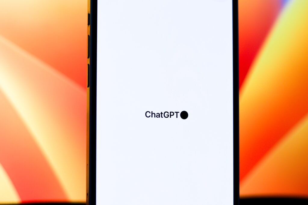Smartphone displaying the ChatGPT app interface against a colorful background