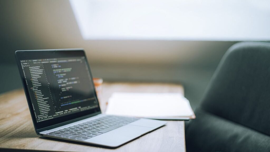 How to Make a WordPress Plugin That Does Something Useful Laptop showing code on a bright desk