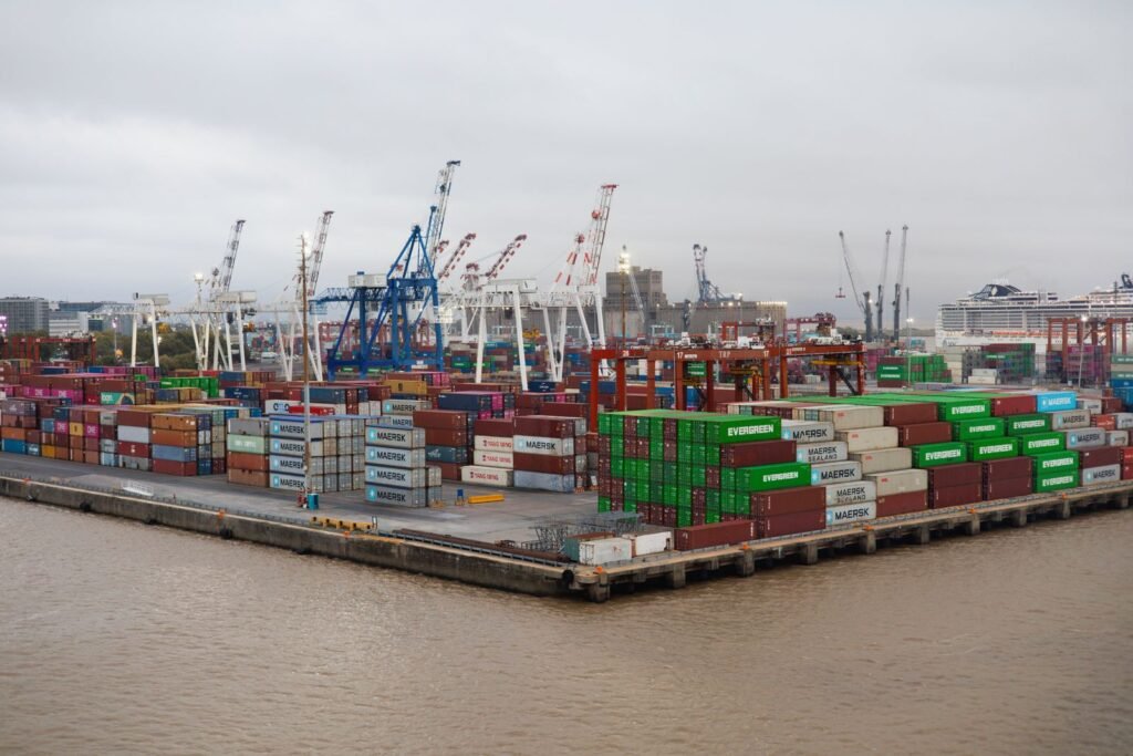 How to Access a Minikube Service From Outside the Cluster Busy shipping port with stacked cargo containers representing exposing a Minikube service