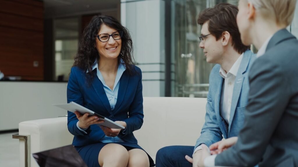Professionals discussing business strategy in an office lounge