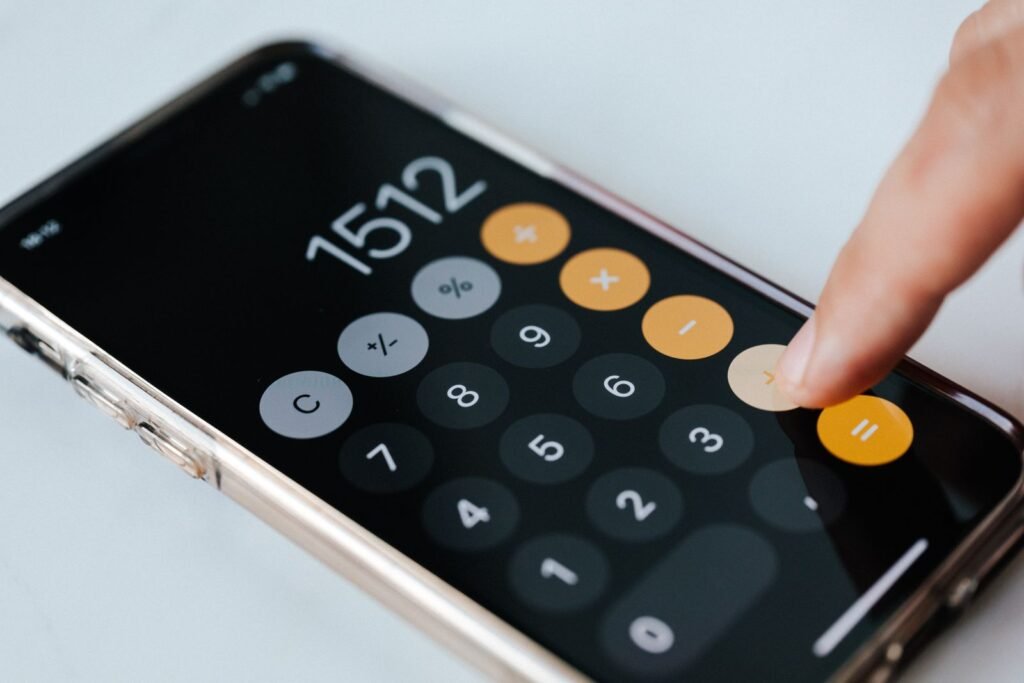 Close up of a calculator display with decimal numbers for comparing floats in Jinja2