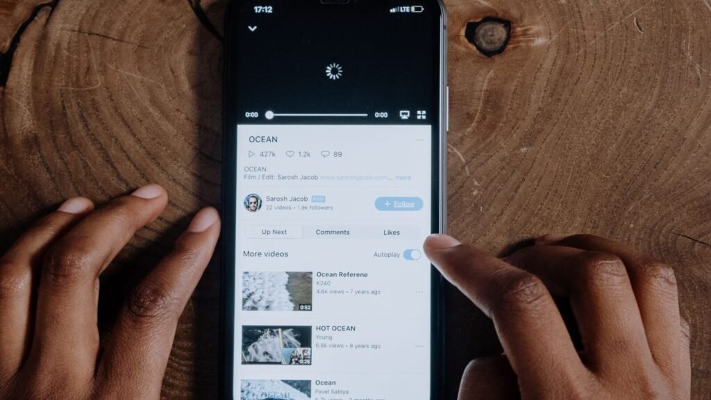 A smartphone loading a video, illustrating Google's AI age estimation using search and YouTube viewing history in Canada