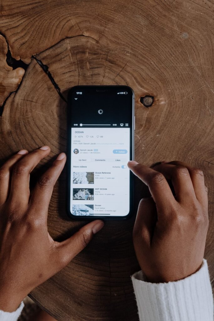 Google Is Guessing Canadians’ Ages From What They Search. Getting It Wrong Costs You an ID Upload. A smartphone loading a video, illustrating Google's AI age estimation using search and YouTube viewing history in Canada