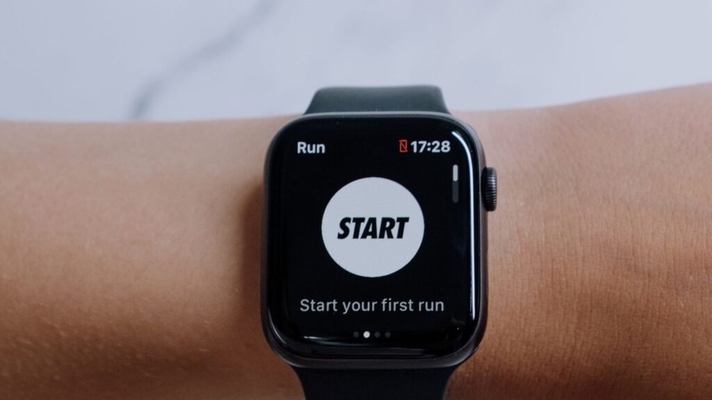 Smartwatch showing a running app on a marble surface