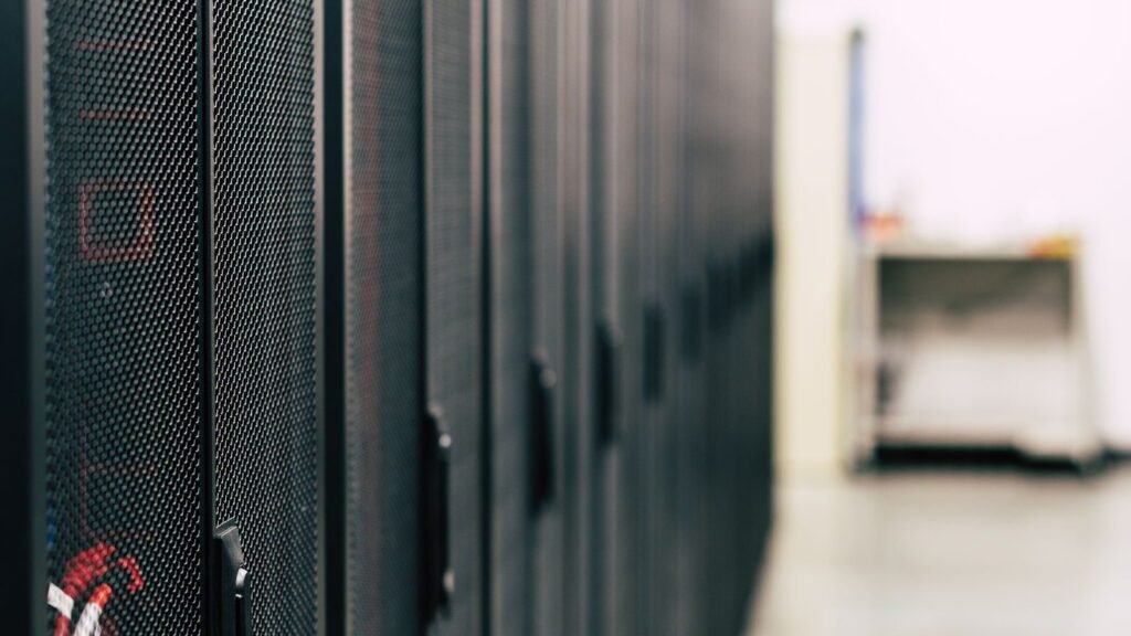 Rows of server cabinets with red network cables