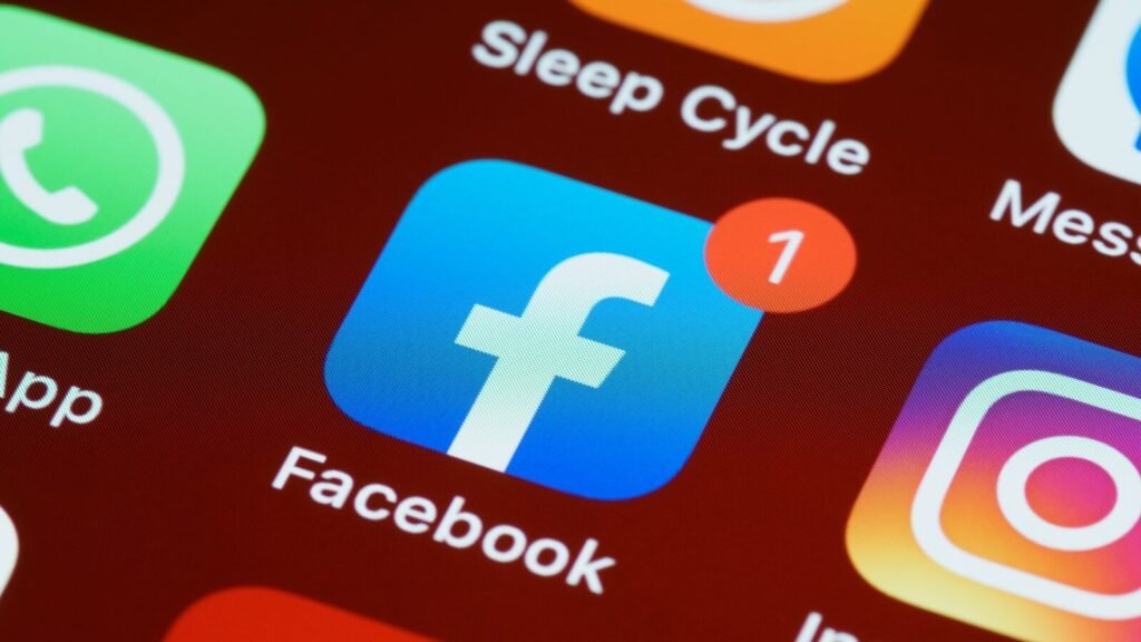 Using the Facebook SDKs in Mobile App Development Social media app icons on a smartphone screen