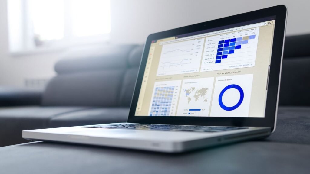 Laptop displaying data analytics graphs in a bright room