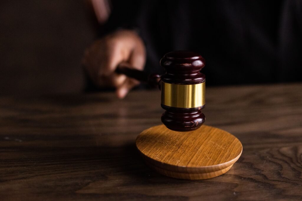 A Jury Says Apple Owes $5.7 Billion for the iPhone’s Buzz. History Says It Will Pay Far Less. A wooden judge's gavel resting on a table, illustrating the federal jury verdict ordering Apple to pay Taction Technology