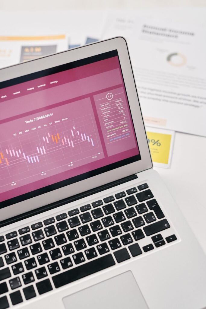 How to Track Two Websites With Google Analytics 4 (One Property or Two?) Laptop showing website analytics graphs for tracking traffic
