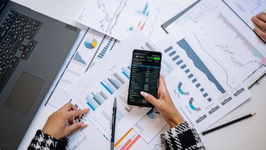 Charts and a smartphone on an office desk for data analytics
