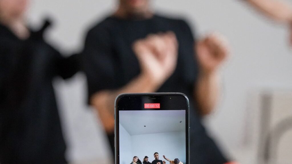 Group recording a dance video on a smartphone