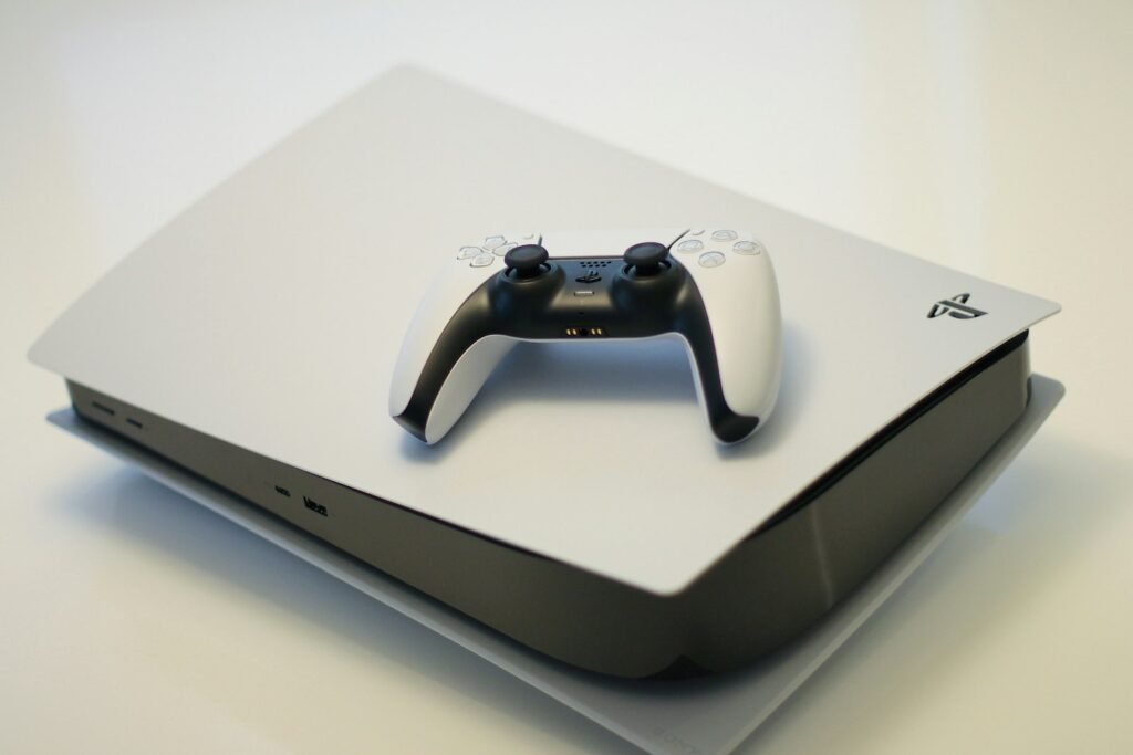 Sony Got $508 Million Back in Tariff Refunds. Its Lawyers Say You Are Owed None of It. A white game console and matching wireless controller, illustrating the PlayStation tariff refund dispute