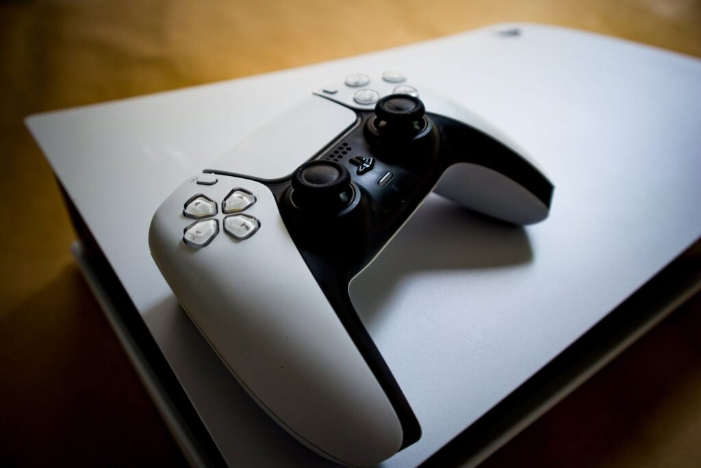 A PlayStation 5 controller resting on the console, illustrating the PSN Digital Games settlement paying store credit
