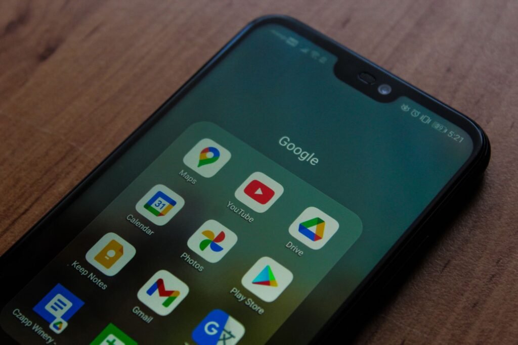 Close up of a smartphone screen showing a group of Google app icons