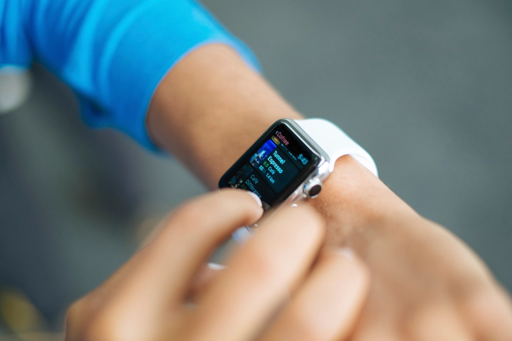 Person checking heart rate and health stats on a smartwatch screen