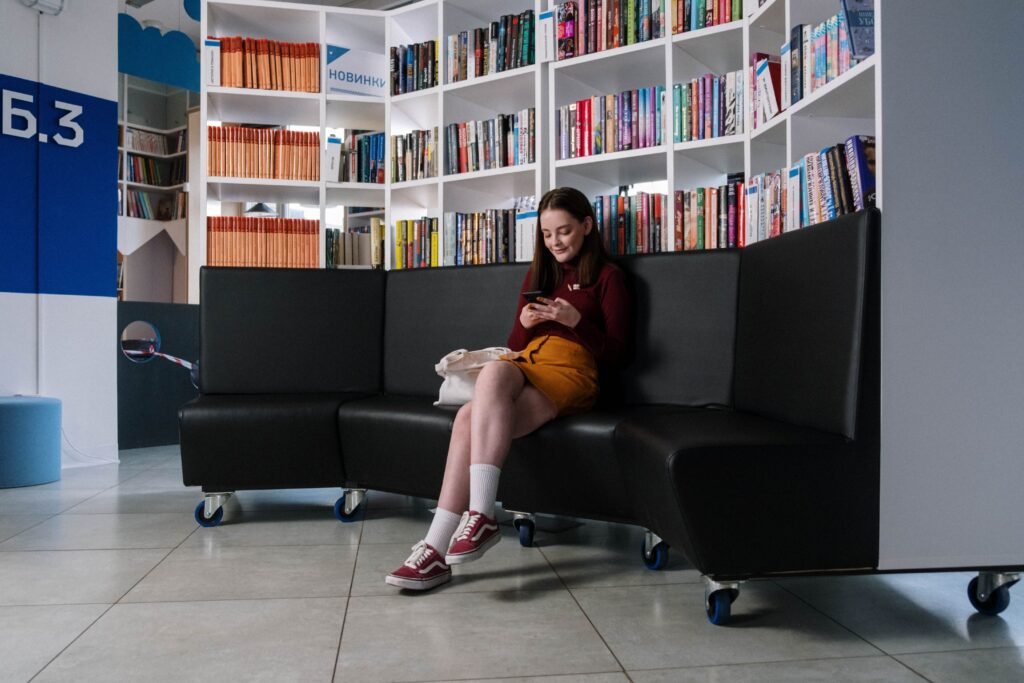 California Will Fine Platforms $1 Million Per Child. Proving the Injury Is the Hard Part. A teenager sitting indoors looking at a smartphone screen