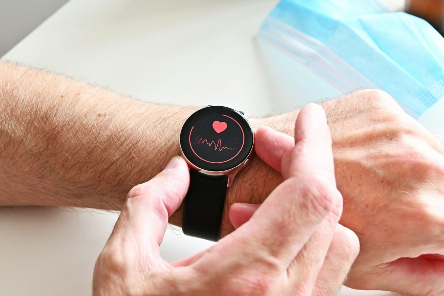 Person checking a heart rate reading on a smartwatch on their wrist