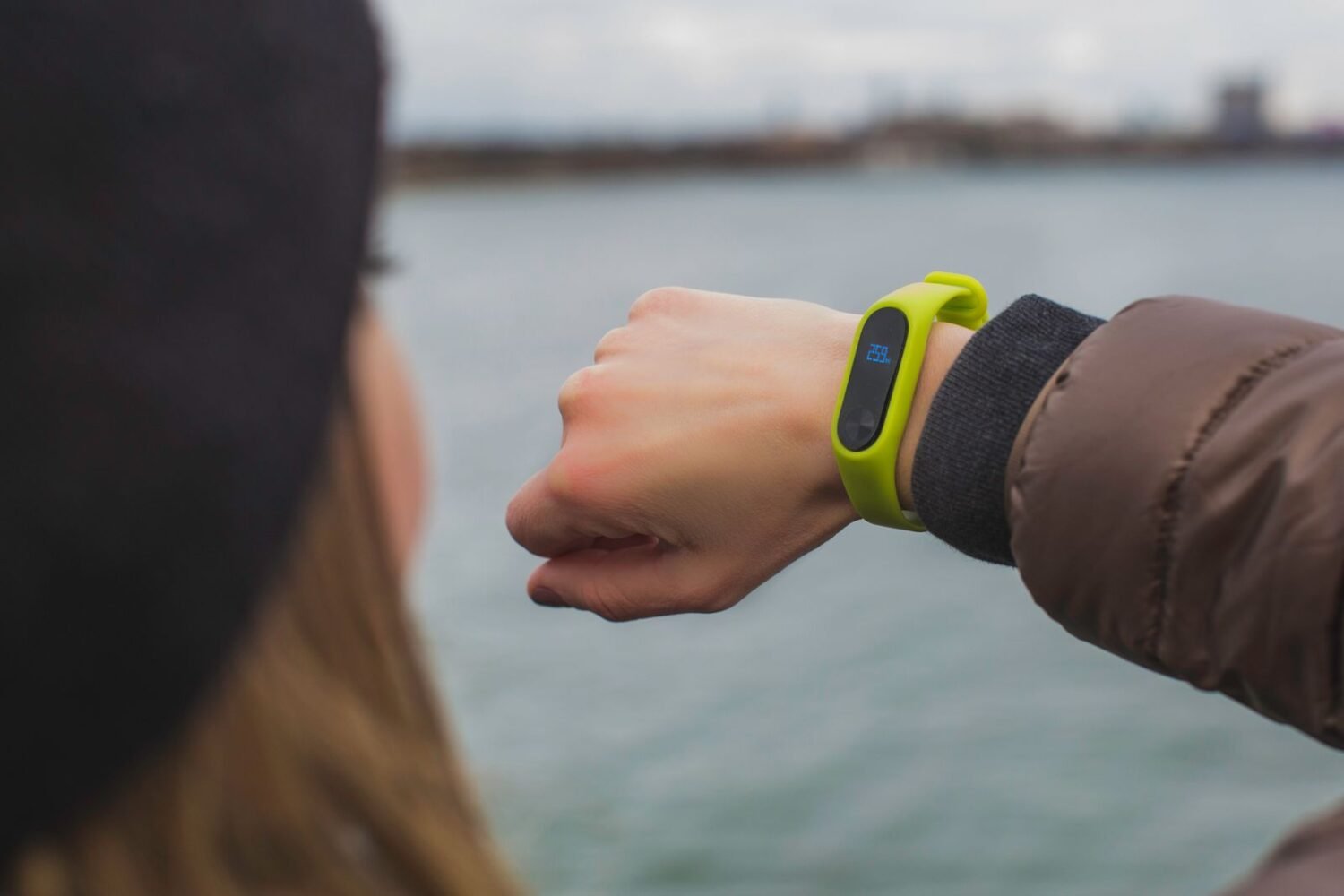 Woman outdoors checking the time and notifications on her smartwatch