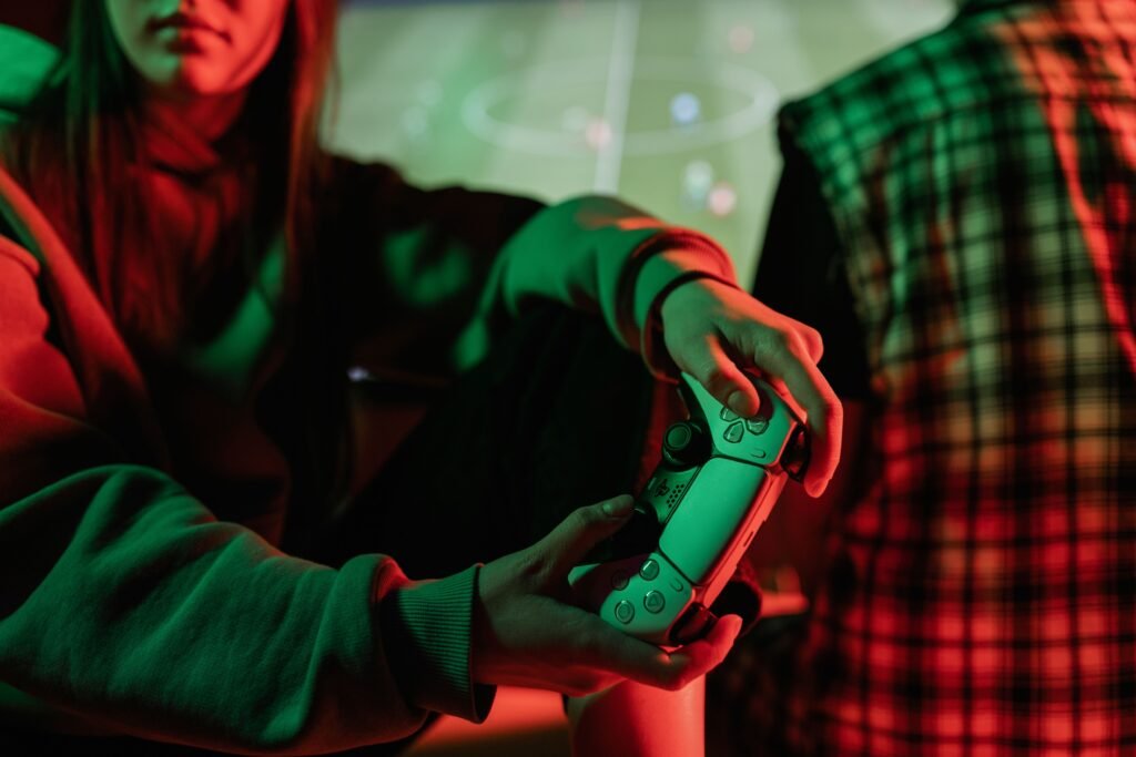 A person holding a game controller while playing, illustrating YouTube's updated gameplay violence monetization rules