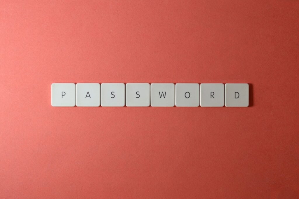White keyboard key tiles spelling the word PASSWORD on a coral background