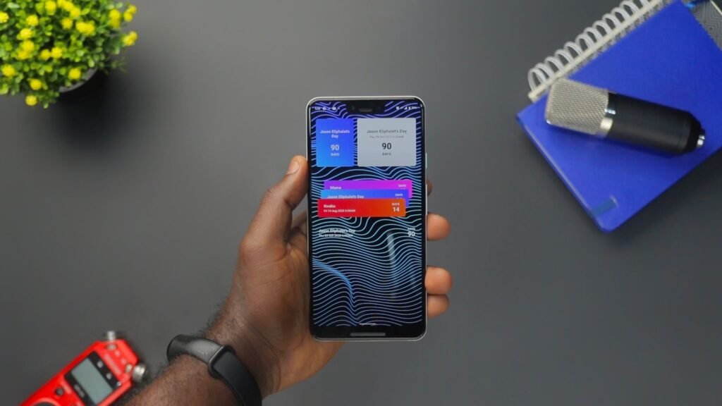 Hand holding an Android smartphone showing a notification, illustrating Google's automatic phone number verification across accounts