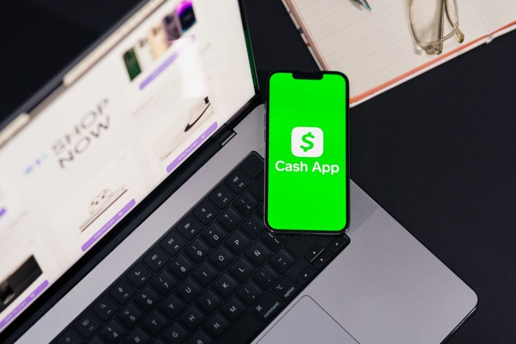 A Scammer Opened a Cash App Account in Her Name. She’s the One Facing Prison. Smartphone showing the Cash App screen resting on a laptop keyboard