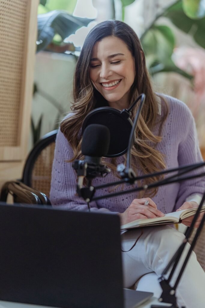 Woman speaking into a studio microphone while recording a voice session