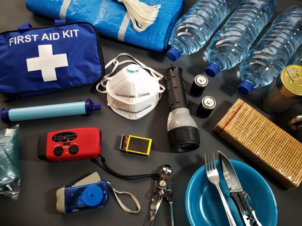First aid and survival kit supplies laid out for an emergency
