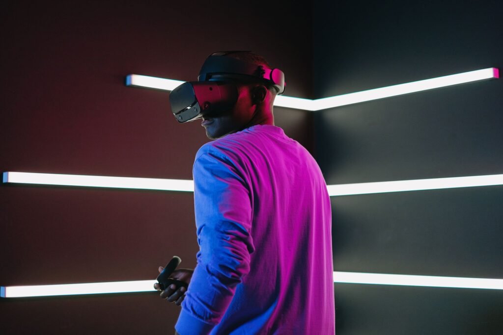 Google’s Genie 4 Holds a World Together for Two Minutes, and Now It Talks Back Man wearing a virtual reality headset standing in a dark room