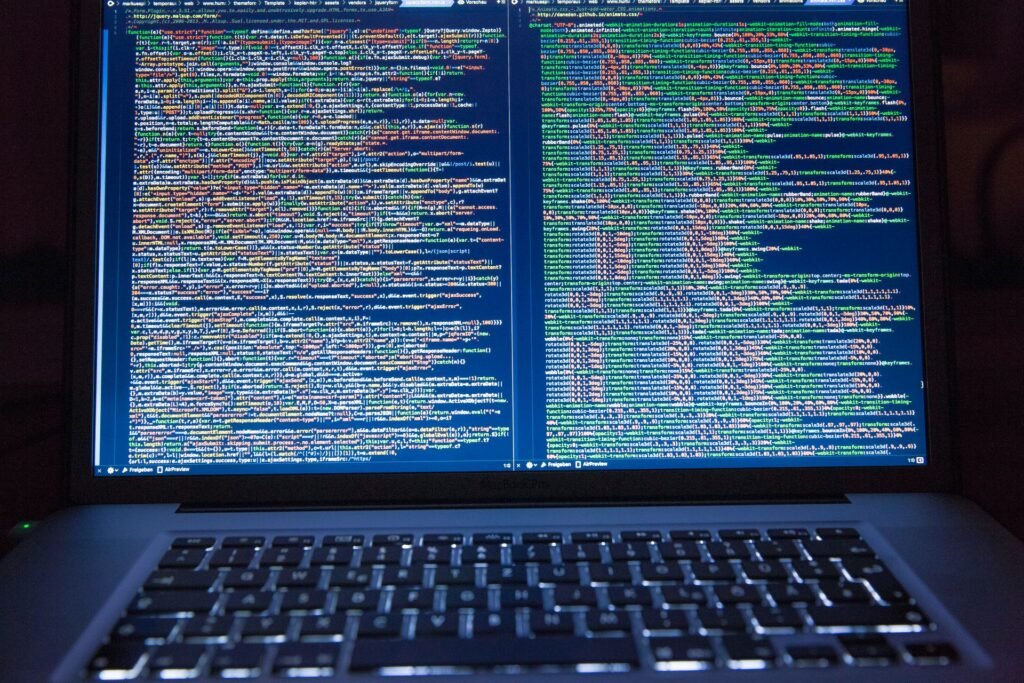 GPT-6.1 Terra Costs $1 per Million Tokens. OpenAI’s Own Chart Still Has Claude Ahead. Black laptop showing lines of computer code on its screen