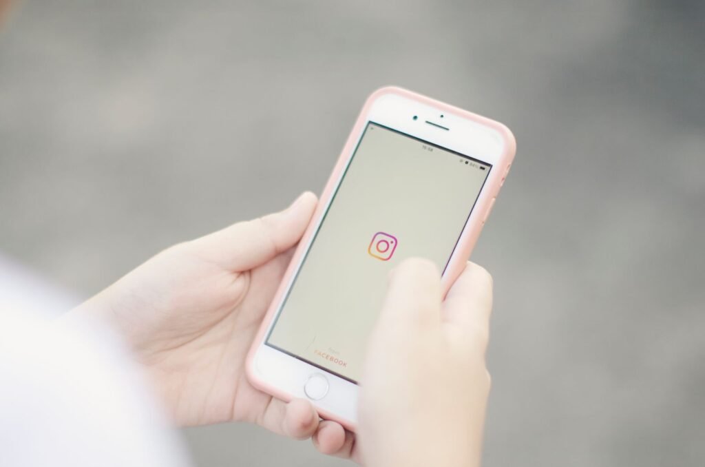 Hands holding a smartphone, scrolling a social media app