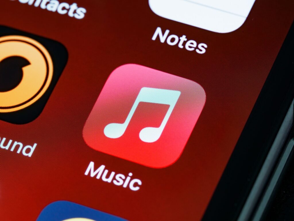Close-up of an iPhone home screen showing the Music and Notes app icons