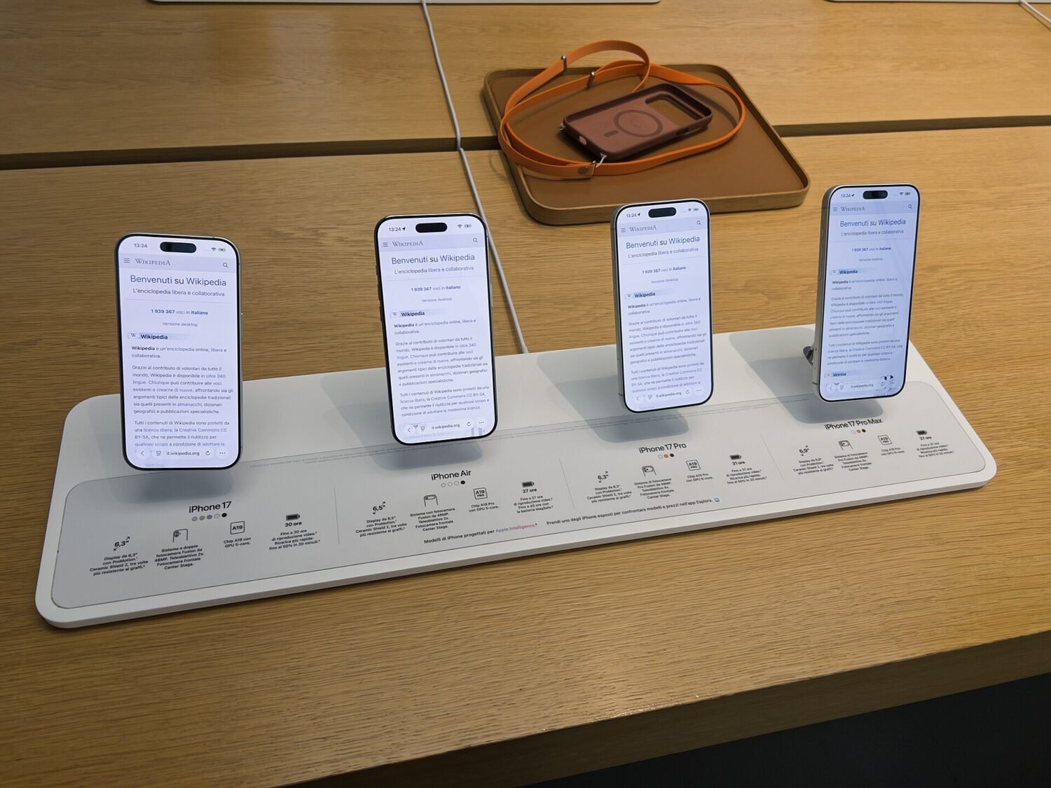 iPhone 17, iPhone Air, iPhone 17 Pro and iPhone 17 Pro Max standing side by side on an Apple Store display table