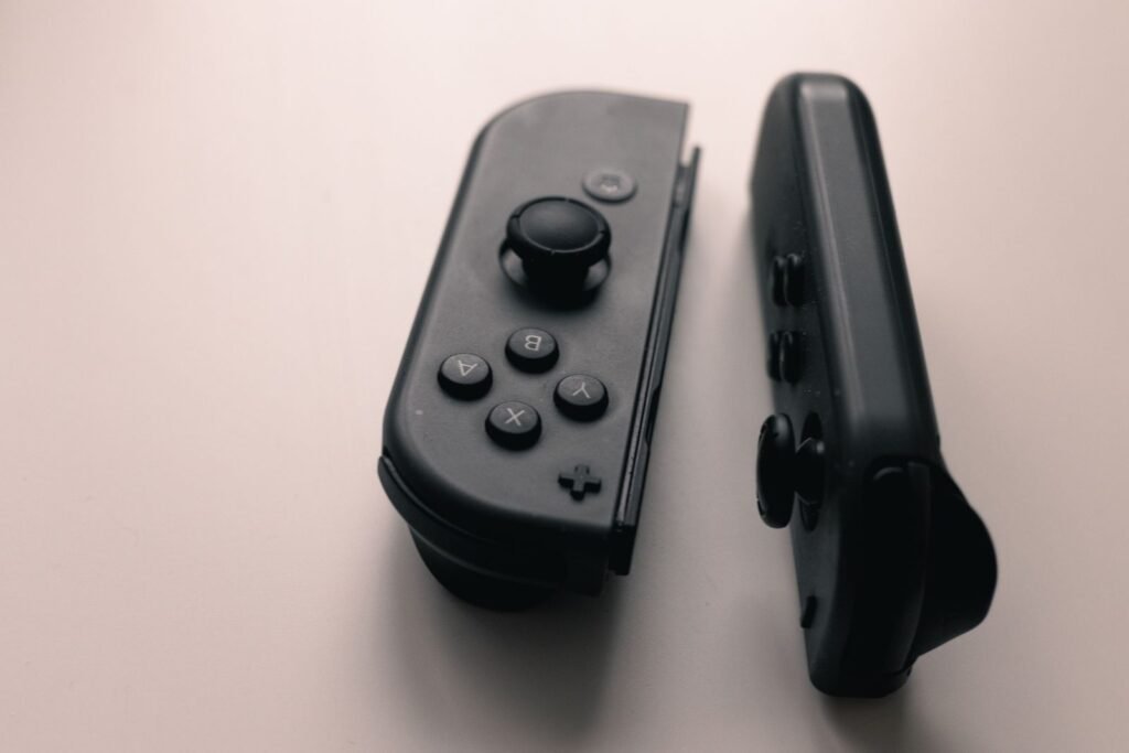 How to Fix Switch 2 Joy Con Drift: Calibrate, Update or Repair Pair of dark gray Joy Con controllers standing side by side on a light background