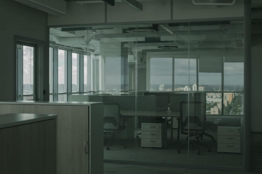 Microsoft Is Offering Buyouts to 60,000 People. Only a Fraction Will Probably Take It. Black rolling chairs beside desks in a spacious glass-walled office