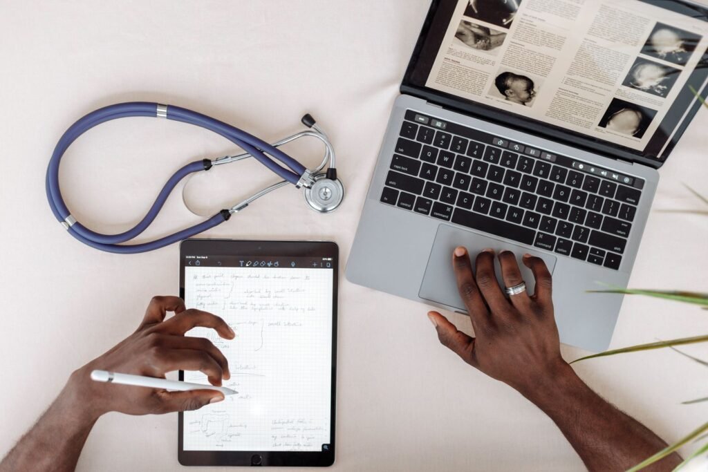Doctor with a stethoscope researching on a laptop