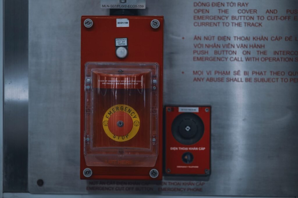 Red emergency stop button on an industrial control panel, a metaphor for an AI emergency brake